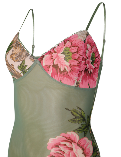 The JULIANNA DRESS - GREEN : FLORAL : ROCCOCO FLORAL by TIGERMIST is a sheer, light green maxi slip dress with thin straps, featuring pink floral prints, Green Rococo Floral leaf patterns, and scalloped trim along the neckline.